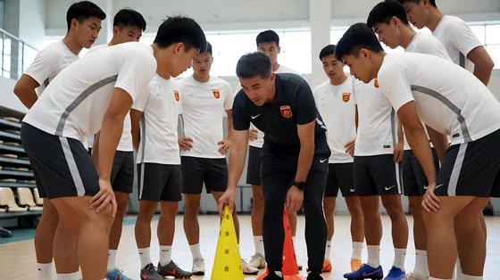足球教练在场边布置战术，球员围拢听取安排